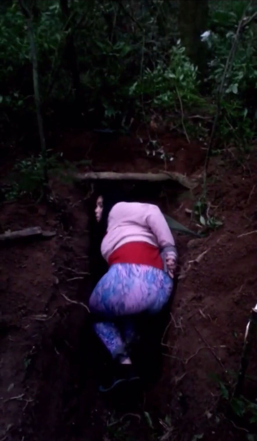 Girl Lays Down In A Shallow Grave For A Quick Execution