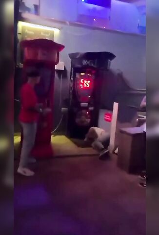 Drunk Idiot Attempts A Flying Headbutt On The Punching Machine