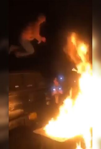 Moron Jumps Into A Flaming Bonfire And Sets Himself On Fire