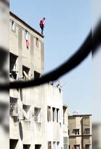 Man In Red Ends It Off A Tall Building