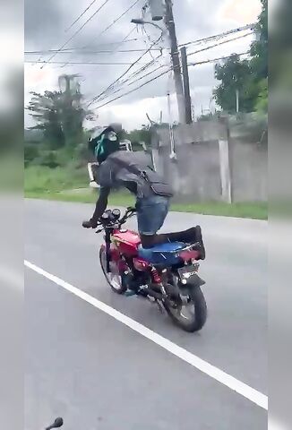 Biker Pulling Wheelies Into Oncoming Van