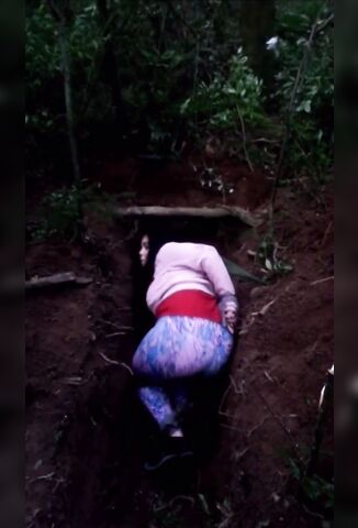 Girl Lays Down In A Shallow Grave For A Quick Execution