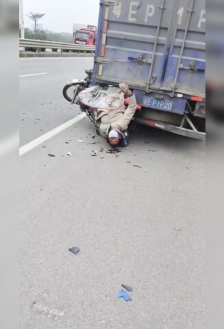 Man On A Scooter Stuck Upside Down After Hitting A Truck