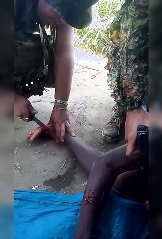 Soldier With A Knife Tortures Another Man Trying To Kimbo Slice His Foot Off