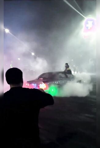 Guy Pointing A Laser At A Drifting Car Walks Straight Into Another