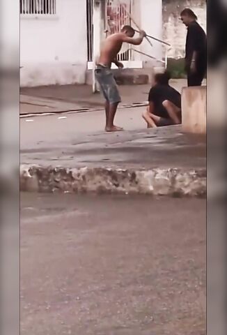 Man With A Knife Stuck In His Forearm Beats His Enemy In The Street