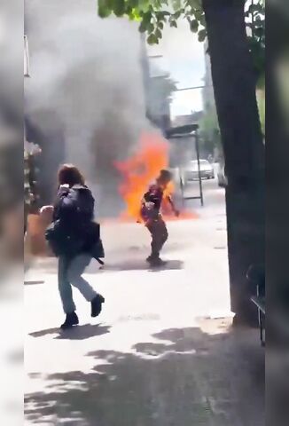 Man Fully Ablaze Walking On The Street As Passers By Try To Help