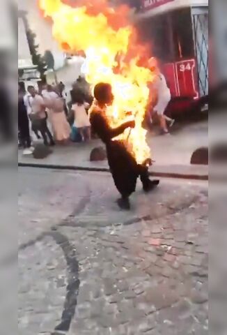 Man Stands And Burns In Front Of Curious Crowd In Istanbul