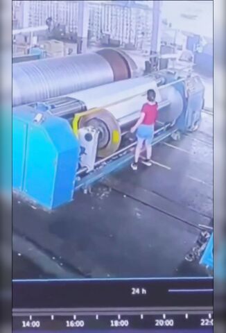 Woman Checking The Fabric Gets Spun Into The Machine