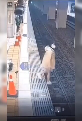 Sad Woman Jumps Onto The Tracks An Cowers Awaiting The Impact