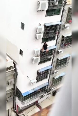 Crazed Girl Falls Off Apartment Cage In China