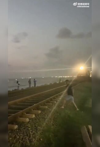 Man Crossing The Tracks Looks The Wrong Way