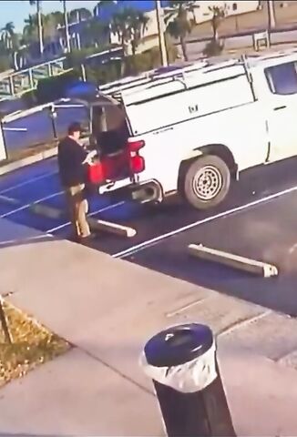 Man Playing With Something In The Back Of His Pickup Truck Lights His Face Up