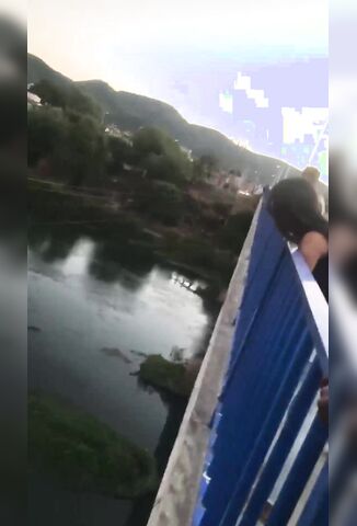 Man Hanging From A Bridge Ends It All in Front of Onlookers