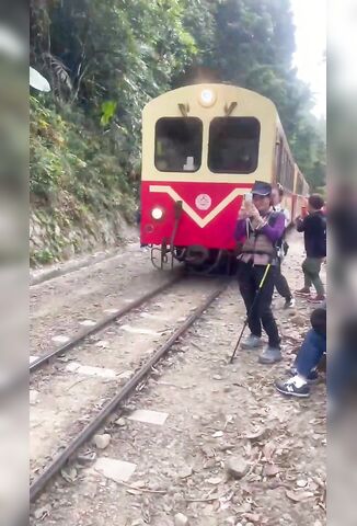 Female Tourist In Taiwan Takes A Selfie With A Passing Train