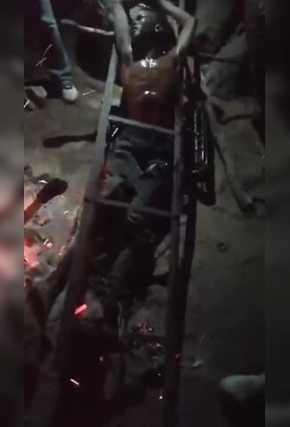 African Man Tortured With Hot Metal While Pinned In A Makeshift Rack