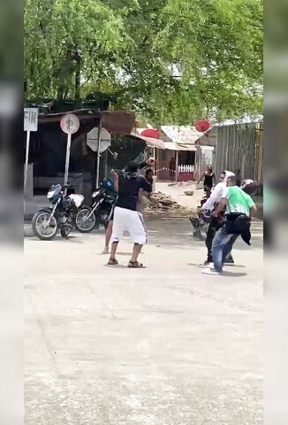 Man With A Machete Gets Stoned Bloody In The Street