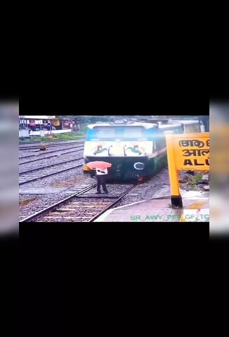 Man With An Umbrella Ends It In Front Of A Train