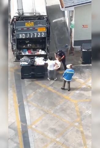Bin Men Have Fun Loading The Trash