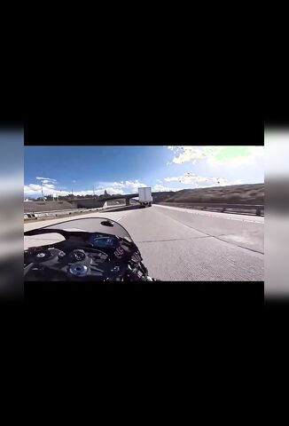 Speeding Biker Weaving Through Traffic Clips The Back of A Trailer