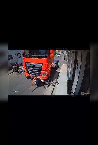 Female Cyclist Tries To Outrun A Red Truck