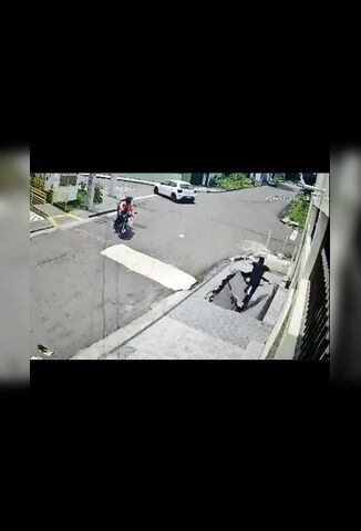 Man Walking On The Sidewalk In Brazil Falls Into The Abyss