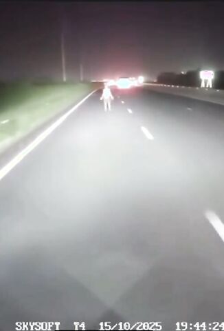 Man Stands In The Road Like Jesus Waiting For The Light