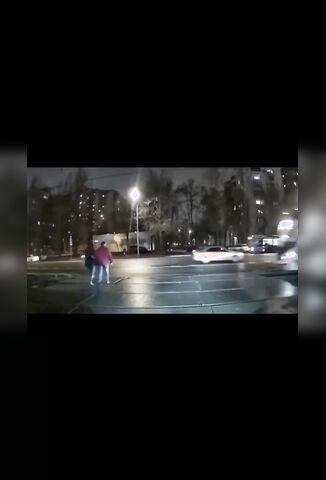 Man And Woman Crossing The Street Totally Oblivious To Oncoming Train