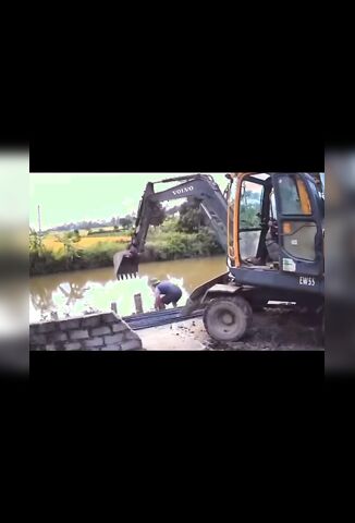 Back Hoe Bucket Falls And Pins Worker Under The Water