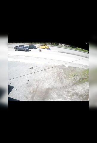 Unlucky Biker Slides Under Oncoming Pickup