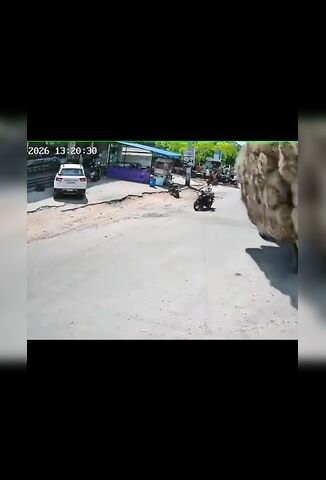 Hay Trailer Topples Over Onto Unlucky Biker