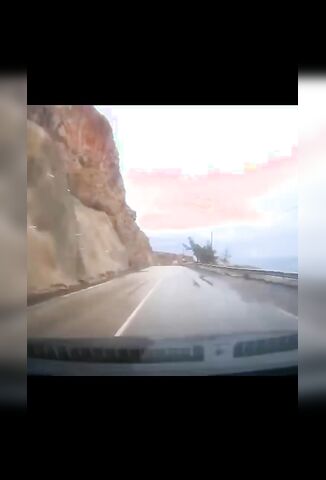 Cliff Collapses On Passing Vehicle